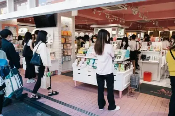 Shoppers browsing a Korean skincare and cosmetics shop in Shin-Okubo.
