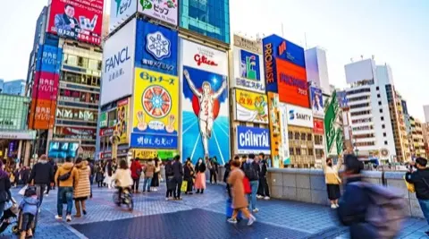 Dotonbori canal lit up with neon at night.