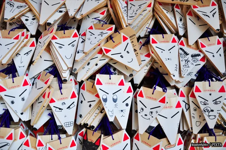 Fox-shaped ema votive plaques — visitors draw a face on the blank fox and write a wish on the back.