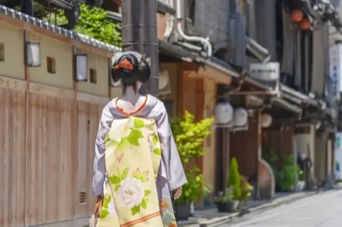 A maiko walking the streets of Gion.