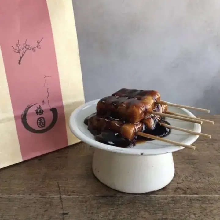 Mitarashi dango to go from Umezono, a Gion sweets shop making the grilled-and-glazed rice dumplings since 1927.