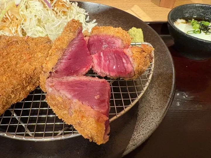 A close-up of the fillet cutlet, sliced to show its rare, tender center.