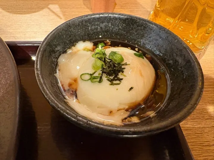 A raw egg side dish for making tamago-kake-gohan, a common gyukatsu set add-on.