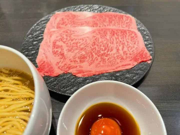 ISSUN BOUSHI's limited Japanese Black Sirloin Ramen, with thin-sliced wagyu to dip into the broth and a raw egg on the side.