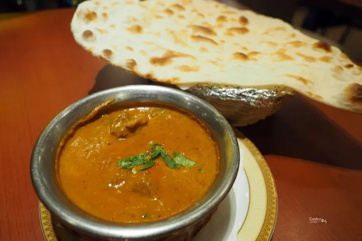 Indian Palace's coconut curry lamb, served with fresh-baked naan.