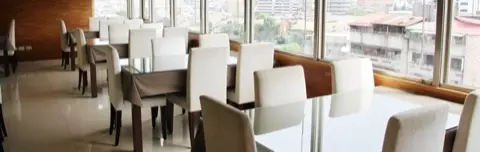 Dining hall with a Taipei skyline view.