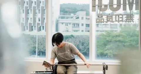 Working at the glass station by the window.