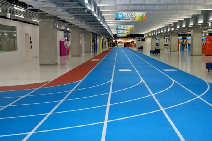 Terminal 3's walkways, marked out like a running track with colored lanes for departing and arriving passengers.