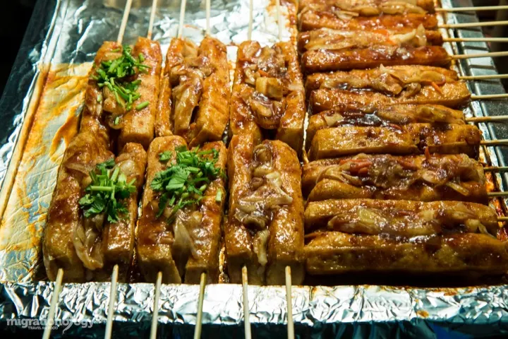 Grilled stinky tofu skewers, glazed and charred.