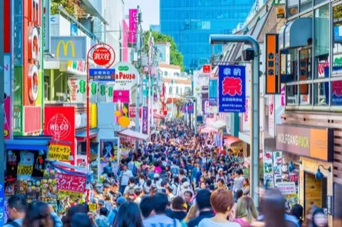 Crowds exploring Takeshita Street's shops.