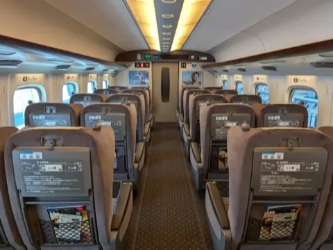 Green Car cabin, 2-by-2 seating.
