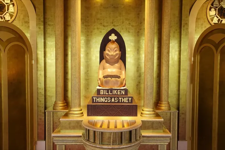 The lucky Billiken statue on Tsutenkaku Tower's golden observation deck — rub the soles of his feet for good luck.