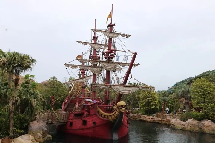 Peter Pan's Never Land in Fantasy Springs, with Captain Hook's Jolly Roger ship anchored in the bay.