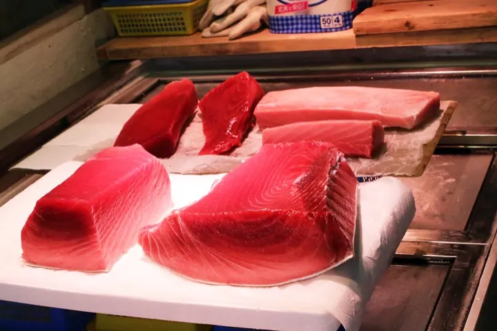 Fresh-cut tuna blocks on display, ready to be sliced into sashimi.