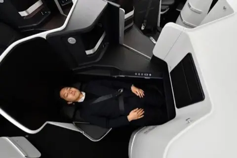 ZIP Full-Flat business class seat, reclined.